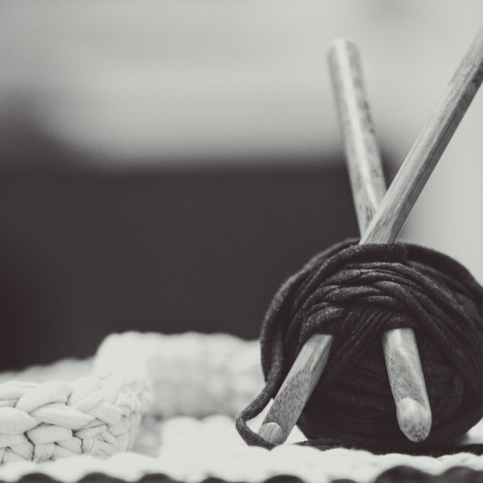 gray wooden sticks with black yarn