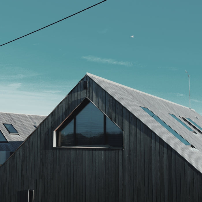 gray wooden house near body of water