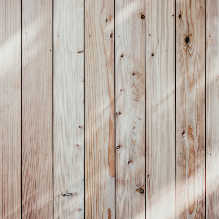 a close up of a wooden wall with a light shining on it