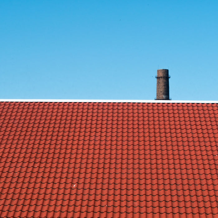 brown roof across blue sky