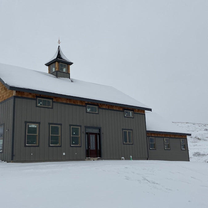 brown and white wooden house on snow covered ground