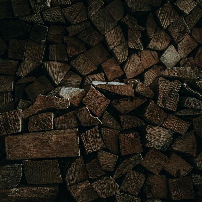 a pile of chopped wood sitting on top of a wooden floor