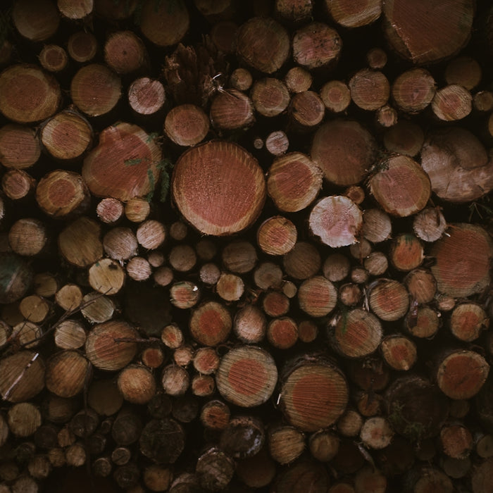 a large pile of logs stacked on top of each other
