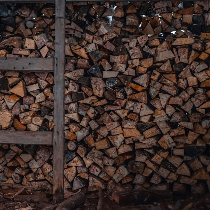 a pile of wood sitting next to a ladder
