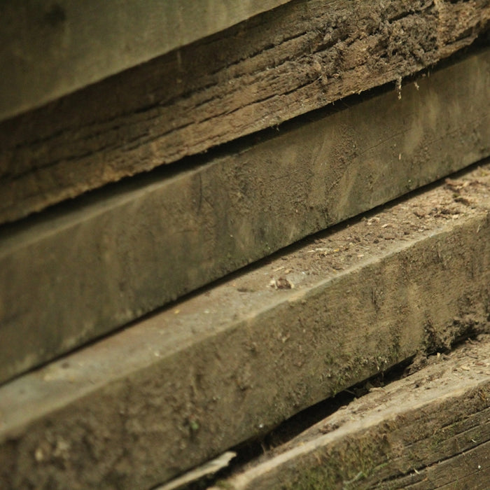 a close up of a bench made of wood