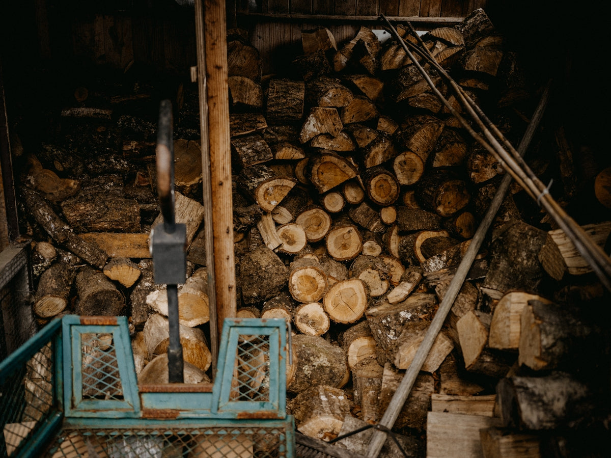 a pile of wood sitting next to a pile of logs