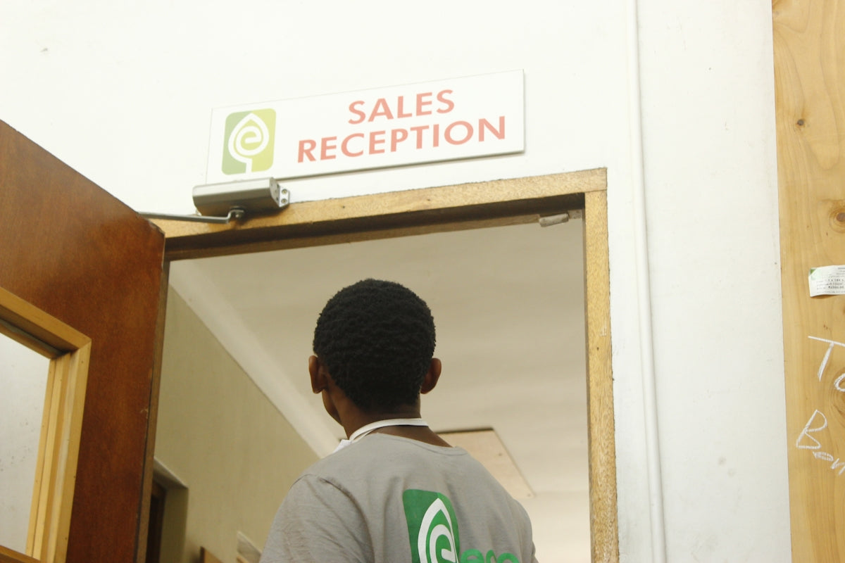 Man walks towards sales reception door.