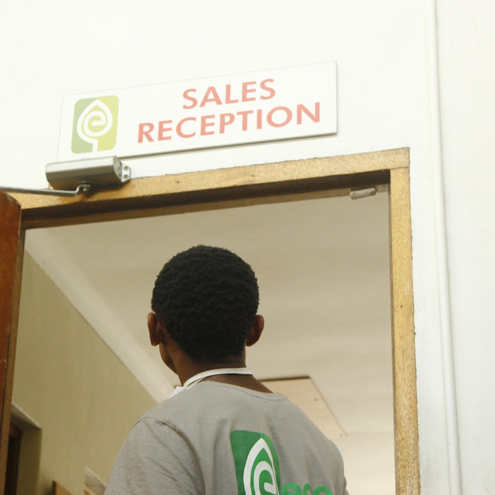 Man walks towards sales reception door.