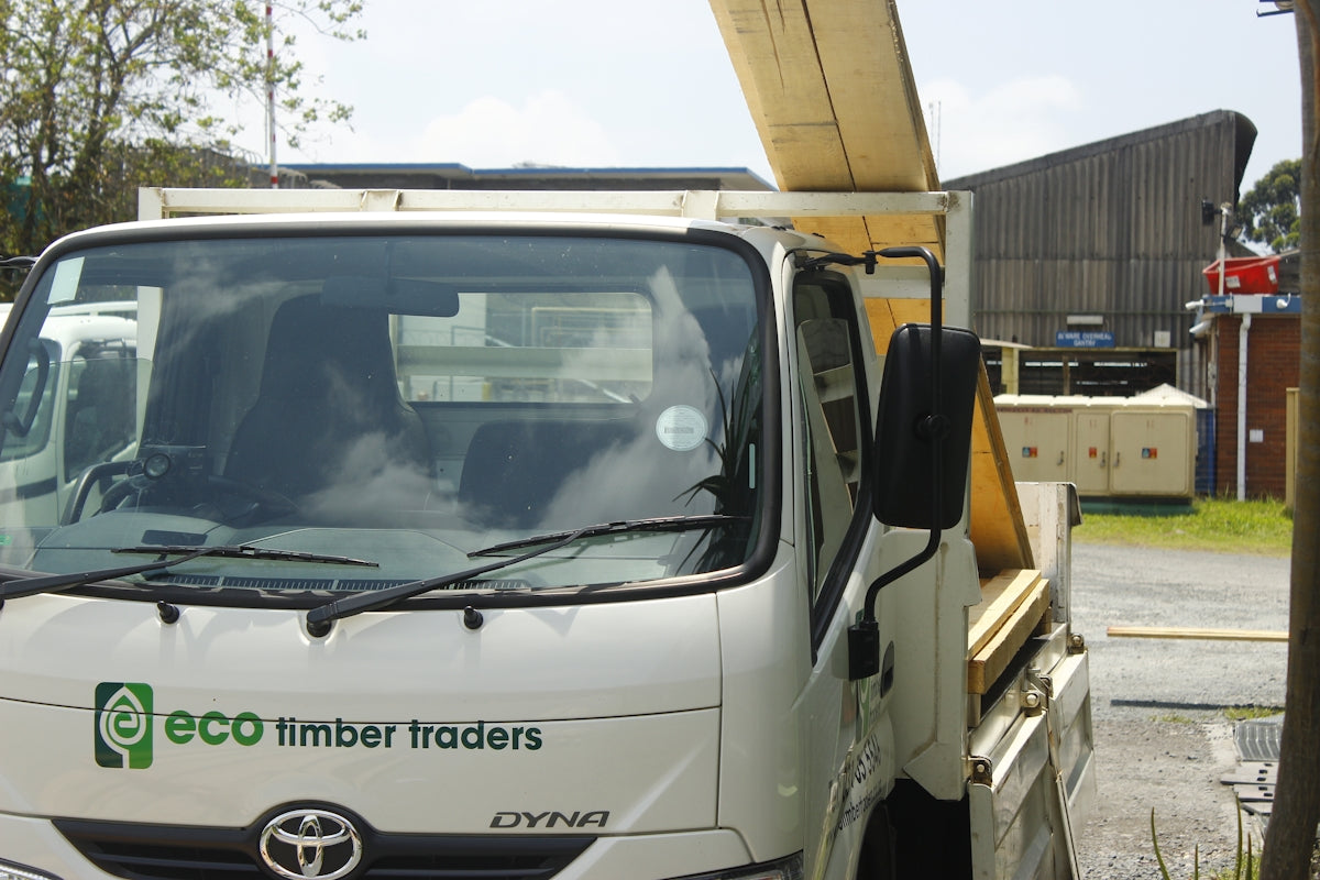 White truck with eco timber traders logo on it