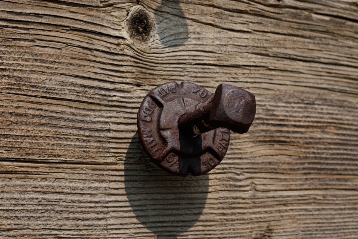 a close up of a door handle on a wooden door