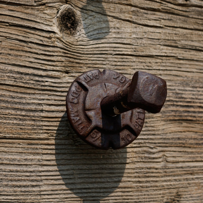 a close up of a door handle on a wooden door