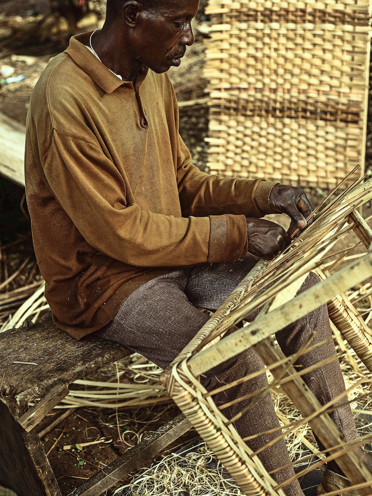 a man sitting on top of a wooden bench