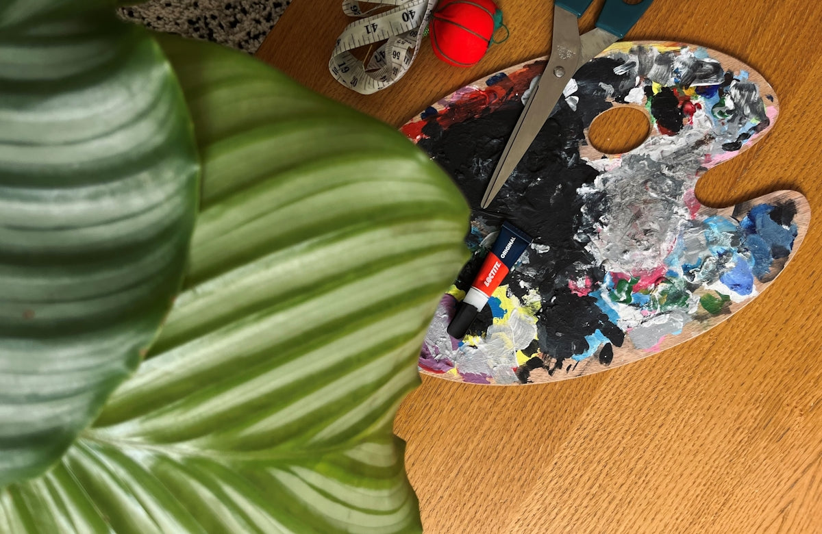 a pair of scissors sitting on top of a wooden table