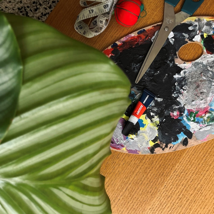 a pair of scissors sitting on top of a wooden table
