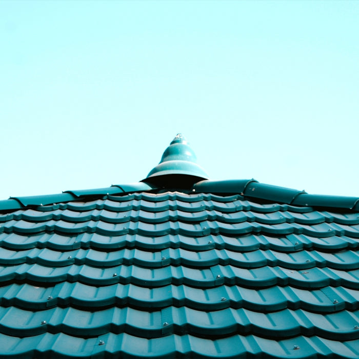 a close up of a roof with a blue sky in the background