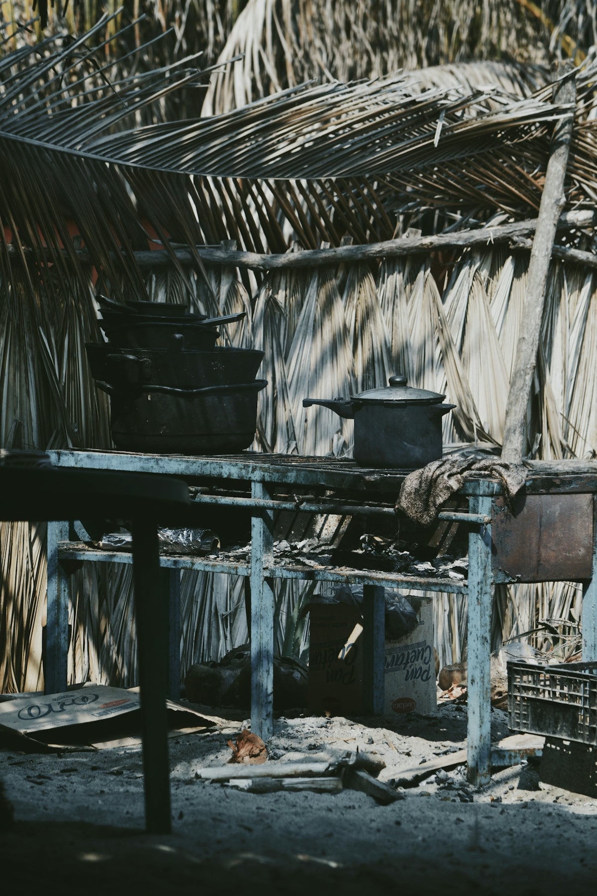 a wooden table sitting in front of a hut