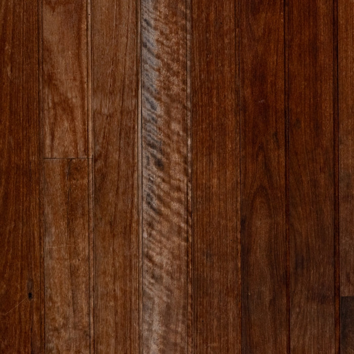 A close up of a wooden floor with a brown stain