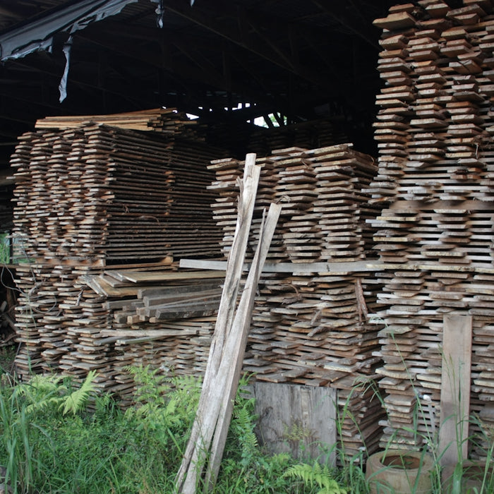 A pile of wood sitting next to a building