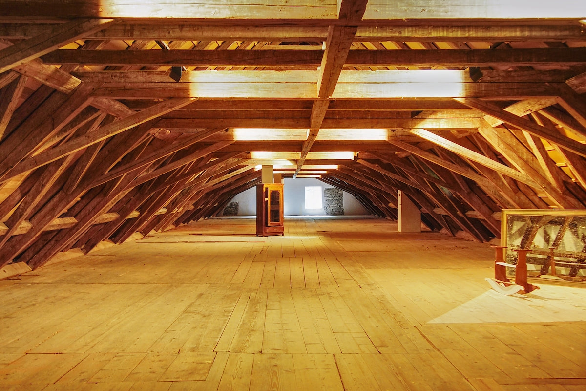 A large room with wooden floors and beams