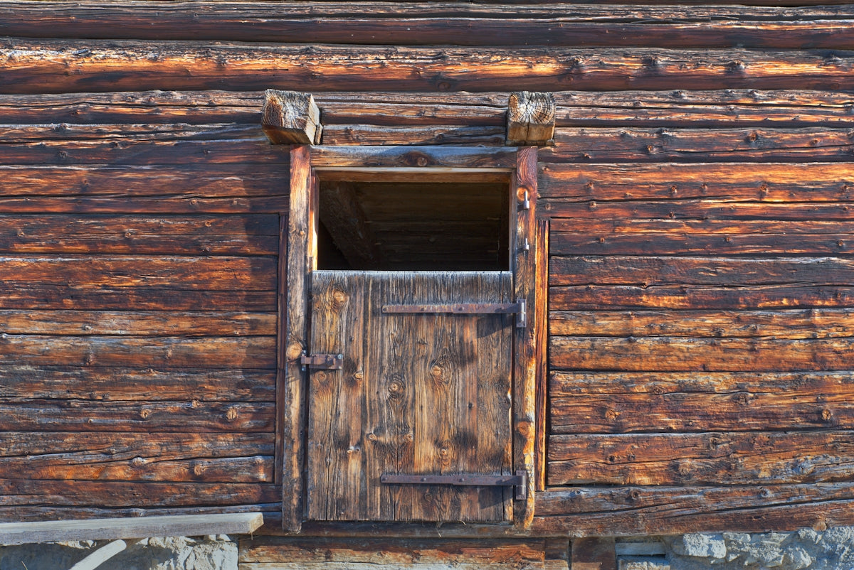A close up of a wooden building with a window
